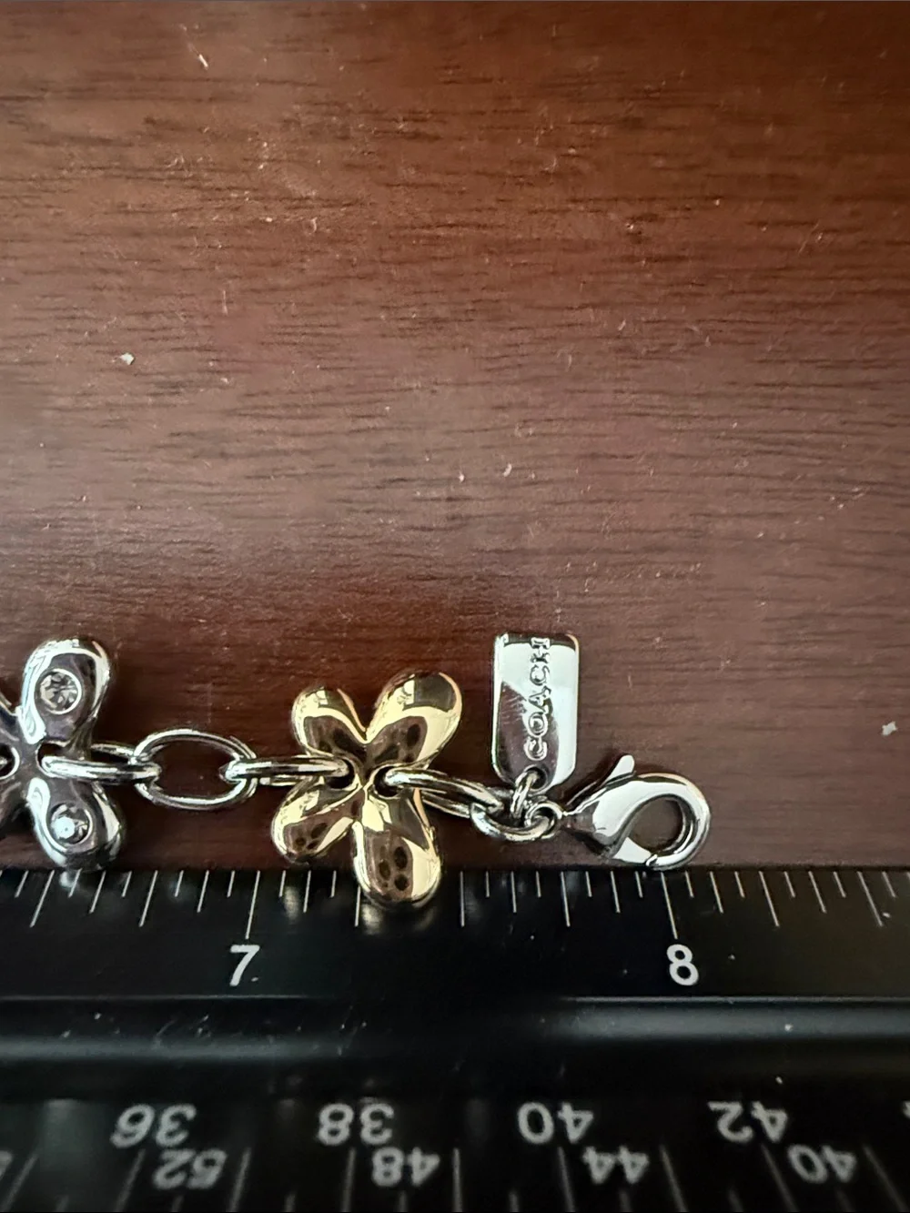 Coach Two-Tone Floral Charm Bracelet in Gold and Silver